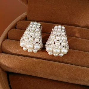Close-up of elegant court style pearl stud earrings with zircon accents in jewelry box