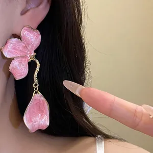 Vintage pink enamel flower drop earrings with golden accents and silver needles for women