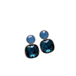 Vintage square blue crystal stud earrings with silver-tone setting on white background