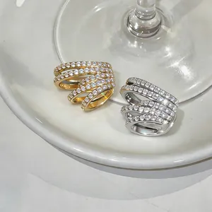 Close-up of gold and silver multi-layer ear cuffs with sparkling zircon stones