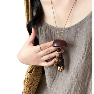 Bohemian long wooden seed necklace for women with ethnic style on linen dress