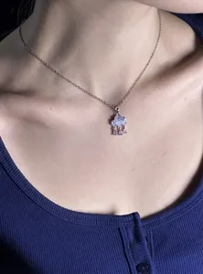 Close-up detail of a light blue cloud pendant necklace with sparkling zircon drops