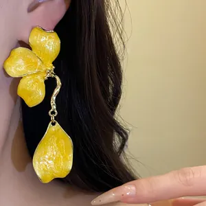 Close-up detail showing the texture of vintage yellow enamel flower dangle earrings