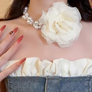Elegant white pearl necklace with a large chiffon flower for summer beach fashion style