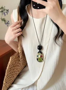Detailed macro view of a New Chinese ethnic style long necklace with a green tassel