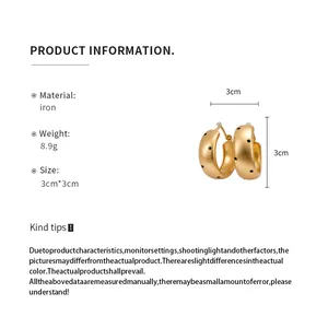 Golden chunky hoop earrings with black polka dots including 3cm dimension and material details