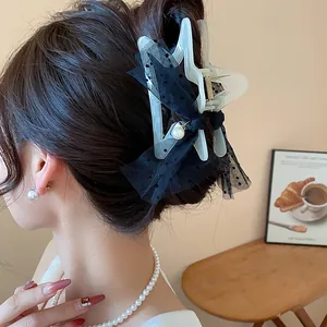 Star hair claw clip with black mesh polka dot ribbon and pearl detail for women