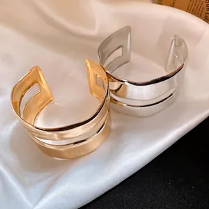 Minimalist irregular double-layer gold and silver metallic open cuff bracelets on silk