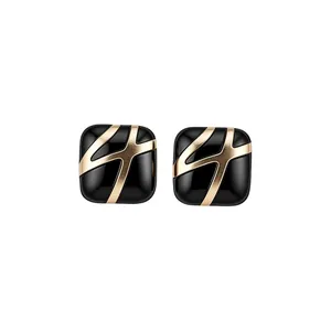 Square black enamel stud earrings with gold geometric lines for a vintage luxury look