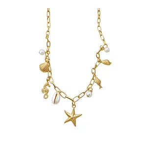 Gold nautical charm necklace with starfish, sea shell, seahorse, fish and pearls