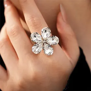 Elegant and exaggerated sparkling rhinestone flower open ring displayed on model's hand