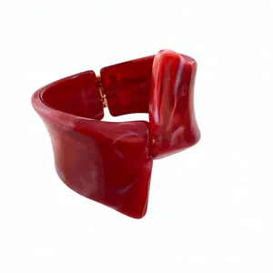Elegant red marbled resin chunky bangle with irregular geometric twisted design and hinge