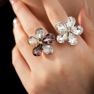 Detailed macro shot of elegant floral rings with sparkling pear-cut crystal petals