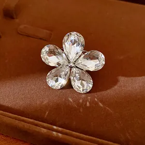 Close-up of elegant flower-shaped crystal ring with sparkling teardrop petals