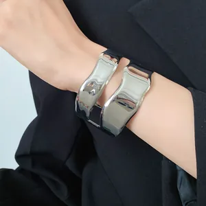 Detailed view of minimalist irregular double-layered silver metal cuff bracelet on wrist