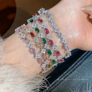 Elegant flower zircon bracelet set with colorful sparkling stones shown on person's wrist