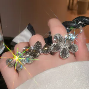 Detail close-up of sparkling crystal flower open ring with heavy rhinestone embellishment