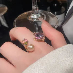 Close-up of luxury open ring featuring purple gemstone and pearl for banquet.