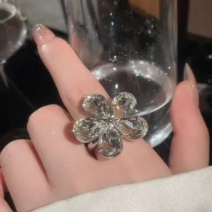 Detail of heavy industry flower ring with sparkling pear-shaped crystals on hand