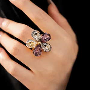 Detailed close-up of a luxury floral open ring featuring colorful teardrop crystals