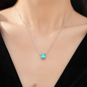 Detail view of cushion-cut blue zircon necklace on model wearing black velvet