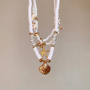 Elegant handmade polymer clay and pearl beaded necklace with gold starfish and shell charms