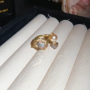 Close-up of champagne crystal and pearl open ring on jewelry display roll