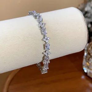 Macro detail of elegant flower and oval-cut cubic zirconia stones on silver bracelet