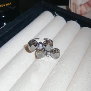 Detailed view of a luxury adjustable ring featuring double sparkling crystal bows