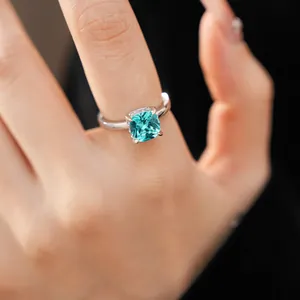 Close-up of a minimalist silver ring featuring a radiant square turquoise zircon stone.