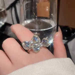 Detailed macro shot of a sparkling bow flower ring with pear-cut crystals for women