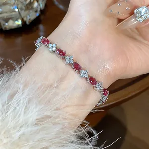 Elegant close-up of flower zircon bracelet featuring red oval gemstones on a lady's wrist