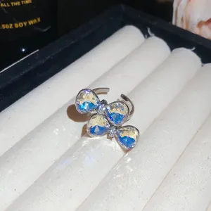 Detailed macro view of butterfly open ring with iridescent AB crystals and rhinestones