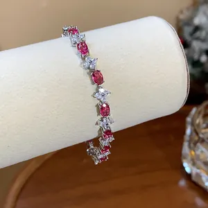 Detailed view of elegant flower bracelet with pink oval gemstones and clear crystals