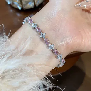 Elegant detail of flower bracelet featuring pink oval zircons and white sparkling stones.