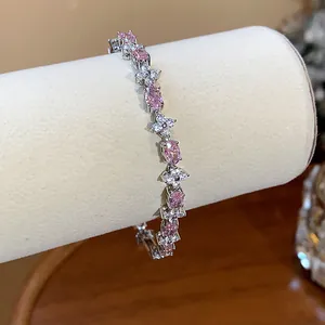 Detail shot of a sparkling flower bracelet with pink and white zircons on a display roll.