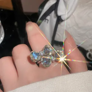 Macro view of a sparkling bow-shaped ring featuring four large heart-cut stones.