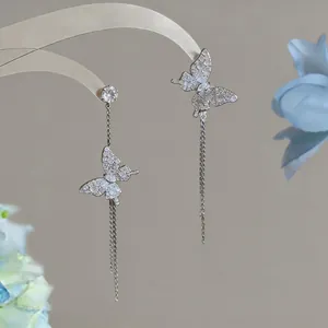 Elegant detail view of silver butterfly tassel earrings with sparkling white zircon stones