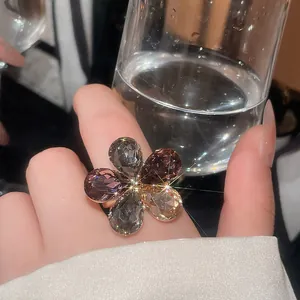 Close-up of elegant flower shaped crystal ring with faceted brown and grey stones