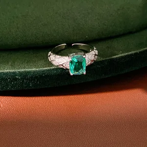 Macro view of a silver adjustable ring featuring a large green cushion-cut emerald zircon.