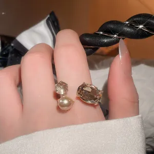 Detailed view of luxury open ring with champagne crystal and pearl accent
