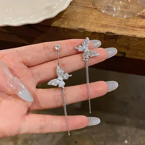 Detailed view of silver butterfly earrings with sparkling zircons and long tassels