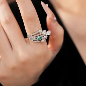 Luxurious multi-layer silver ring featuring a rectangular emerald green zircon and pear stones.