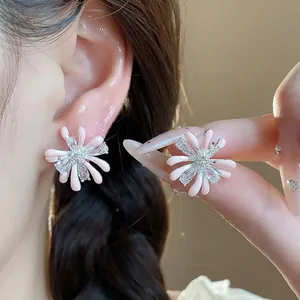 Elegant pink flower stud earrings with shimmering zircons in a fireworks design.