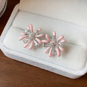 Elegant pink enamel firework stud earrings with sparkling zircons and silver posts.