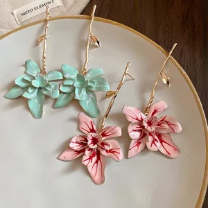 Elegant floral pendant earrings in mint green and pink with gold stem details