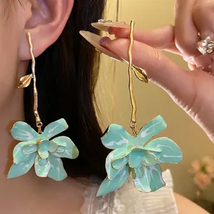 Mint green floral drop earrings with long gold branch stems for vacation beach style