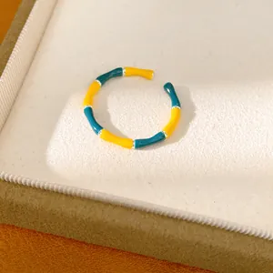 Macro view of retro colorful enamel bamboo joint open ring resting on display tray
