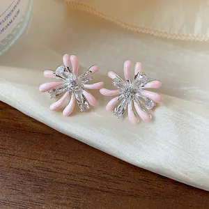 Detailed view of pink enamel firework stud earrings with sparkling zircon stones.