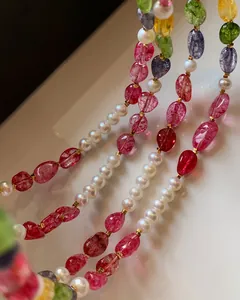 Detailed close-up of colorful crystal beads and pearls in a bohemian necklace set